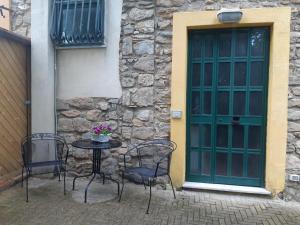 una mesa y sillas frente a una puerta en La casa dell' Agave en Caltanissetta