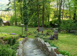a garden with a stone path and a stone wall at Family Relax & Willa Widok in Szczyrk