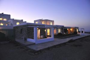 a large house with lights on in front of it at Degaetas Resort in Antiparos