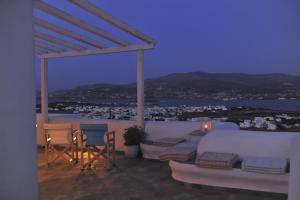 a balcony with chairs and a view of the water at Degaetas Resort in Antiparos