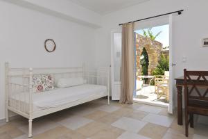 a bedroom with a bed and a sliding glass door at Degaetas Resort in Antiparos