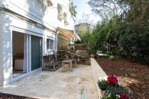 a patio with a table and chairs next to a building at Carmel Boutique - City Oasis in Haifa +10 photos