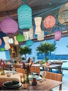 a restaurant with tables and chairs and colorful lights at Wanderlust Experience Hotel in Campos do Jordão