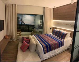 a bedroom with a large bed and a couch at Wanderlust Experience Hotel in Campos do Jordão +7 photos