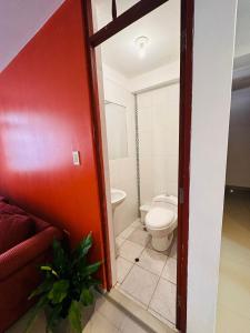 a bathroom with a toilet and a sink at Castellares la Puebla Hostelería Departamento in Ayacucho