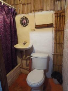 a bathroom with a toilet and a sink at Casa surf arrels in Montañita