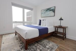 a bedroom with a large bed and a window at 1BR Luxury Apartment Peabody Unit 709 in Peabody