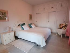 una camera con due letti e una sedia di Seaview Appartment El Mirador in Sitio de Calahonda a Mijas
