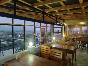a restaurant with tables and chairs and a view of the city at hill-fort kutaisi in Kutaisi