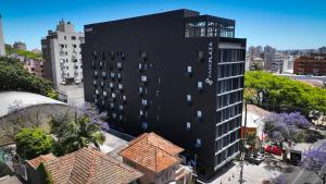 an aerial view of a black building in a city at Park Plaza Moinhos Porto Alegre in Porto Alegre