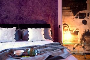 a bedroom with a bed with a reflection of a car at Casa Rossa - byMyHomeinComo in Cernobbio