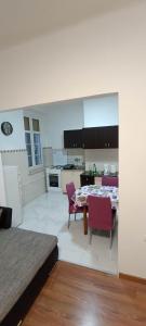 a kitchen and dining room with a table and chairs at Leon in Rijeka