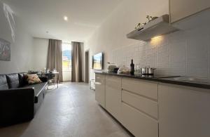 a kitchen with a counter and a couch in a room at New Moon Rooms in La Spezia