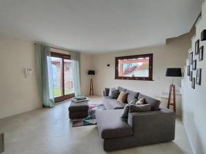 a living room with a couch and two chairs at Fabula Home Rental - Casa Cuneo in Costa Volpino