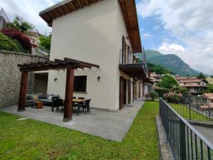 patio domu ze stołem i krzesłami w obiekcie Fabula Home Rental - Casa Cuneo w mieście Costa Volpino