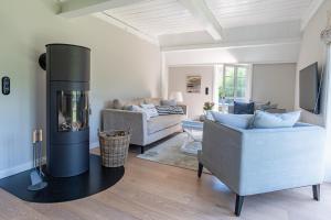 a living room with a fire place in the middle at Green Wening in Borgsum