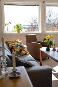 a living room with a couch and a table at Havgaarden, apt 1 in Stapnes