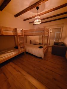 a bedroom with two bunk beds and a couch at Villa Bosna Near Dubrovnik very beautiful Villa entirely privatized swimming pool, jacuzzi, sauna, billiard, ping-pong in Ivanica