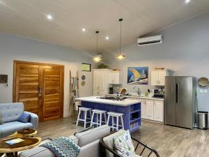 a kitchen with a blue island in a room at An abundance of wildlife at Jungle Glory Home in Manuel Antonio