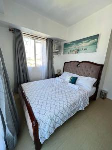 a bedroom with a bed with a large window at 1 BR Centrio Tower 926 in Cagayan de Oro +36 photos