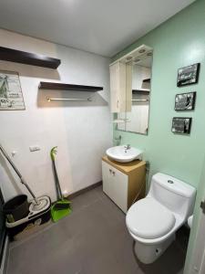 a bathroom with a white toilet and a sink at 1 BR Centrio Tower 926 in Cagayan de Oro