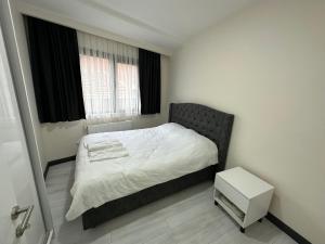 a bedroom with a bed and a small table at Rose Plus Residence in Istanbul