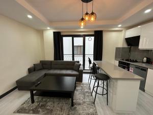 a living room with a couch and a table at Rose Plus Residence in Istanbul