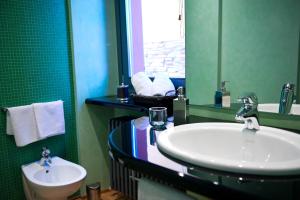 a bathroom with a sink and a mirror at Casa Rossa - byMyHomeinComo in Cernobbio +17 photos