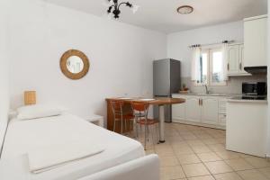 a kitchen with a bed and a table in a room at Almar Apartments in Batsi
