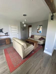 a living room with a couch and a table at Domek „Na Górkach” in Grybów