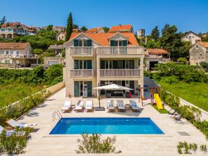 an aerial view of a house with a swimming pool at Villa Janie - Luxury Multi-Level Estate with Pool in Supetar
