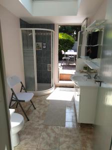 a bathroom with two sinks and a toilet and a patio at LA PORTE BLEUE in Cancale