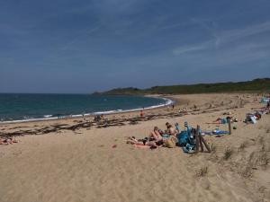 a group of people laying on the beach at LA PORTE BLEUE in Cancale +23 photos