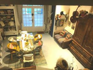 a living room with a table and a couch at La Bégude des Alpilles in Orgon