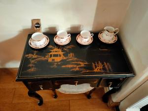 a table with four cups and saucers on it at Central Nottingham Studio in Nottingham
