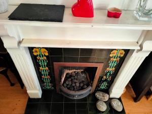 a fireplace with a pile of food inside of it at Central Nottingham Studio in Nottingham