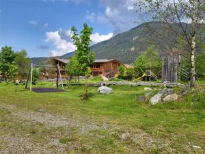 a playground in a yard with a log cabin at Apartments Stoll in Valle Di Casies