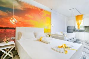 a bedroom with a white bed with a painting on the wall at Suites El Greco in Potos +71 photos