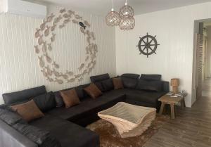 sala de estar con sofá negro y mesa en Lake House Siófok en Siófok