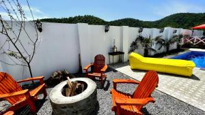 a patio with chairs and a table and a pool at Qafqaz Resort Melisa in Gabala
