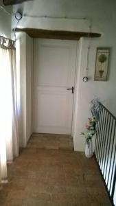 a garage with a white door and a vase of flowers at Ca' Növa in Valverde Pavia