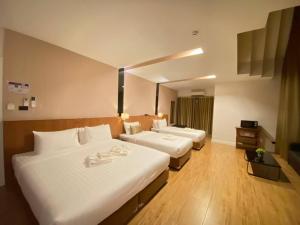 Postel nebo postele na pokoji v ubytování Manomon residence มโนมน เรสซิเดนซ์