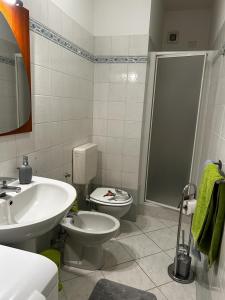 a bathroom with a toilet and a sink and a shower at Dedelollo’s Home in Sanremo