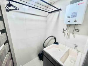 a white bathroom with a sink and a mirror at 2403 Apto privado con vista en el centro de B/ga in Bucaramanga