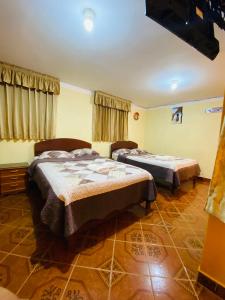 a bedroom with two beds in a room at HOUSE MIRAFLORES in Cajamarca