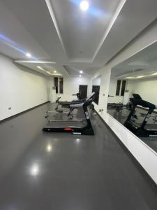 a gym with treadmills and ellipticals in a room at Jivil Shortlets in Lagos