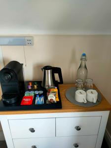 a counter top with a coffee maker and a blender at Lios Éinne House Accommodation in Inisheer
