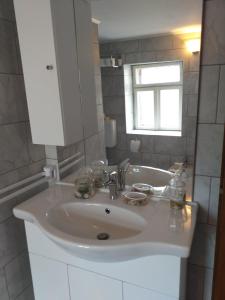 a bathroom with a white sink and a window at Apartment Romy for 2-4 people with jacuzzi in Motovun