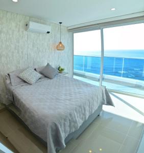 a bedroom with a bed and a large window at Luxury Aparment in Reserva del Mar in Gaira
