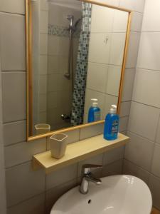 a bathroom with a sink and a mirror at GS APARTMENT in Gythio
